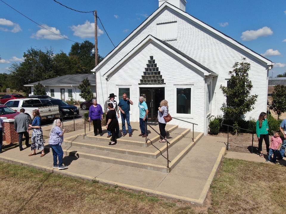 Church family gathered on the front steps after worship